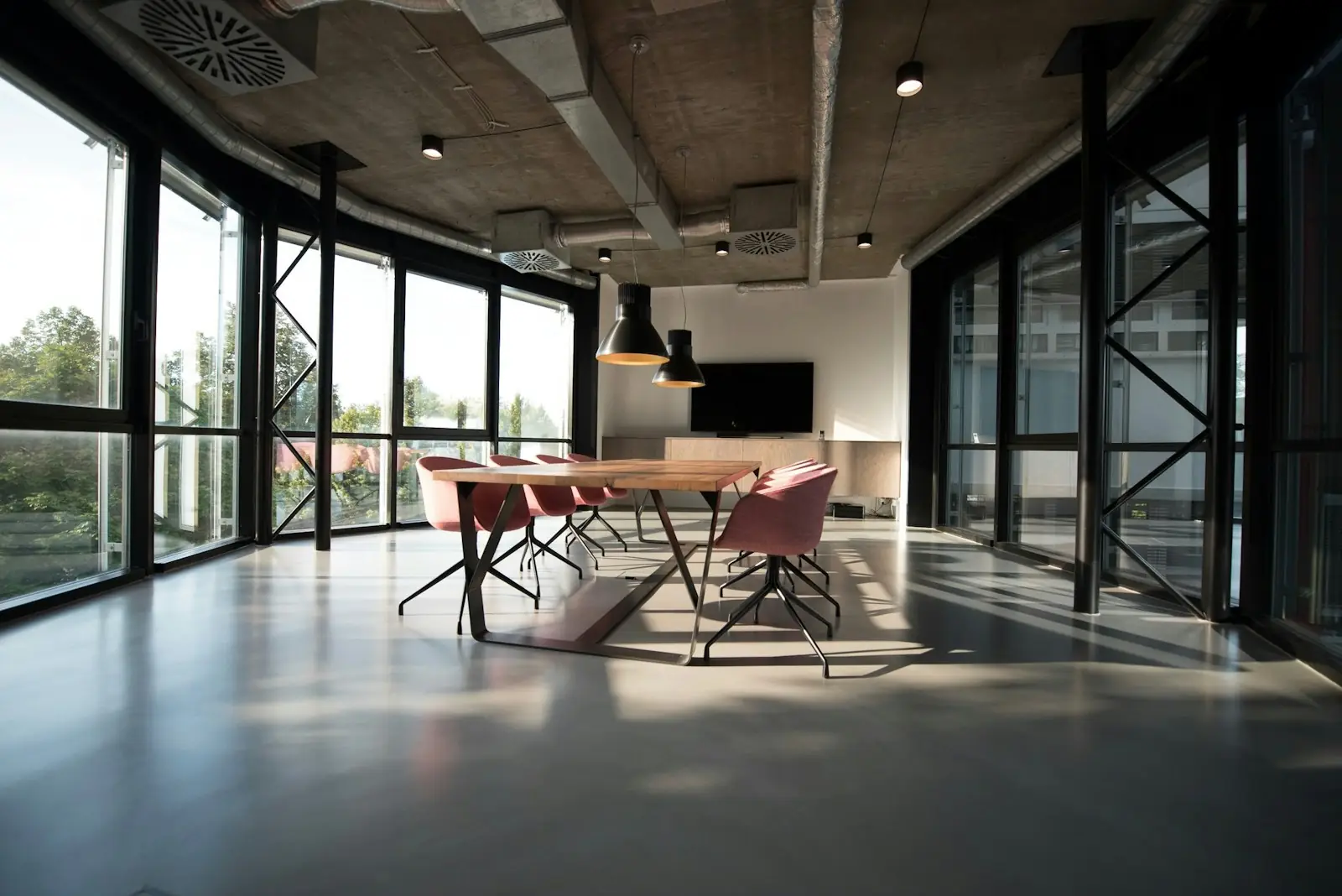 Documentary view of a corporate divestiture office reviewing carve-out documentation